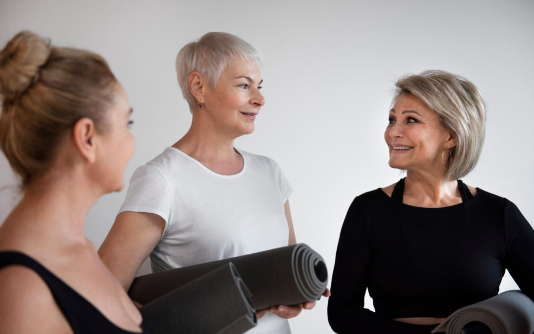 Three women chatting after a Pilates class