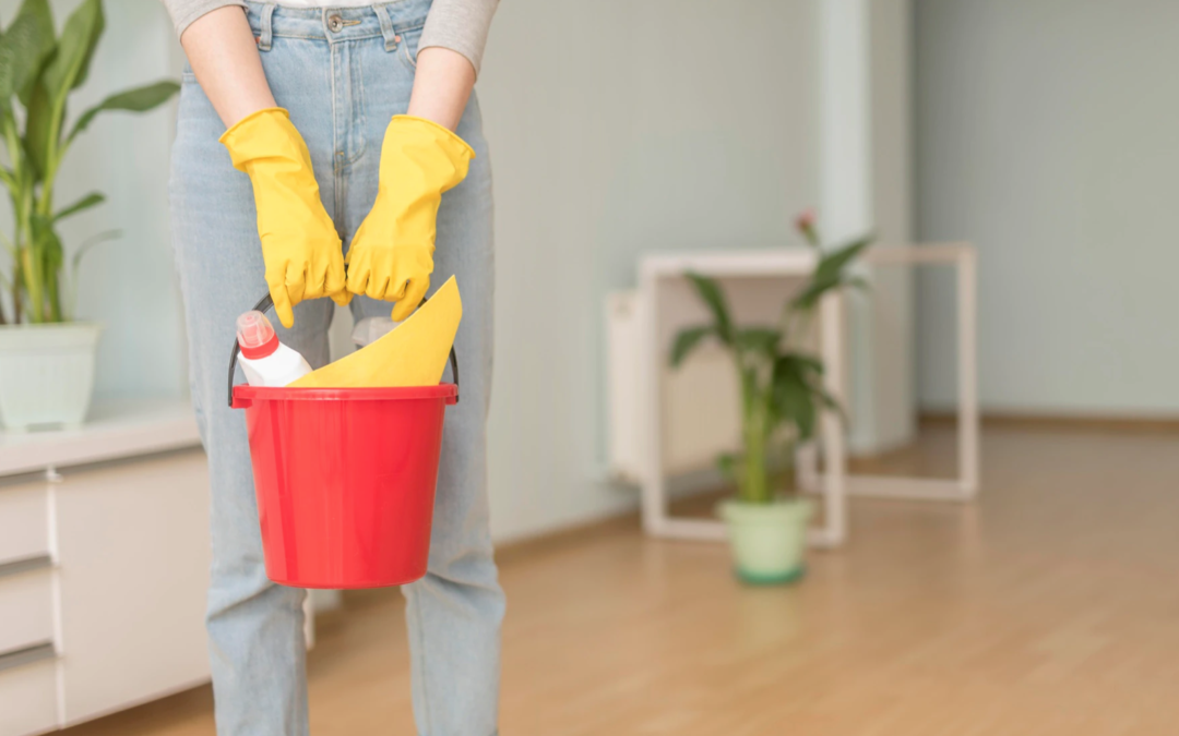 A woman holding a bucket ready to start spring cleaning